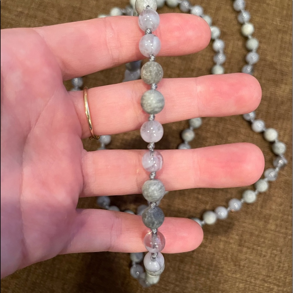 Long stranded circular beaded necklace